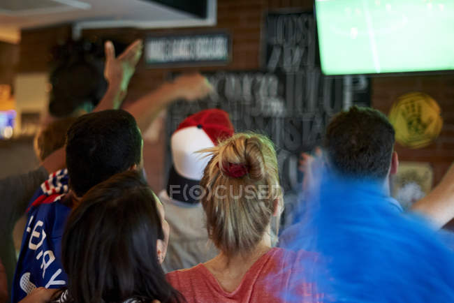 French football fans watching soccer match on television at pub — Stock Photo