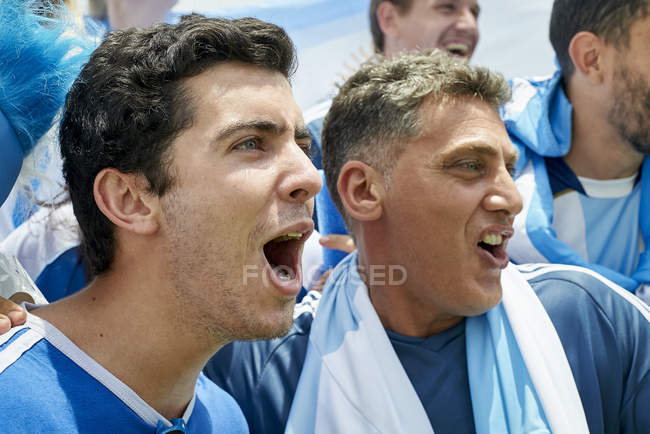 Argentinian football fans watching football match — Stock Photo