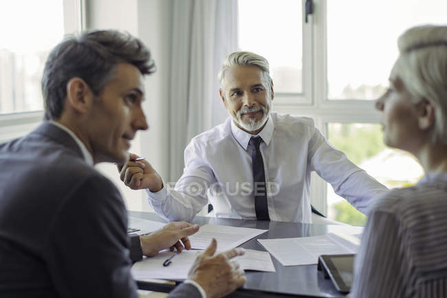 Maturo uomo d'affari incontro con coppia in ufficio — Foto stock