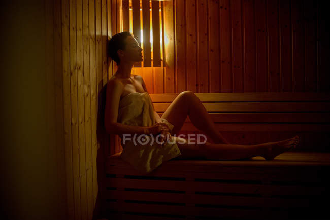 Young Woman relaxing in sauna — Stock Photo