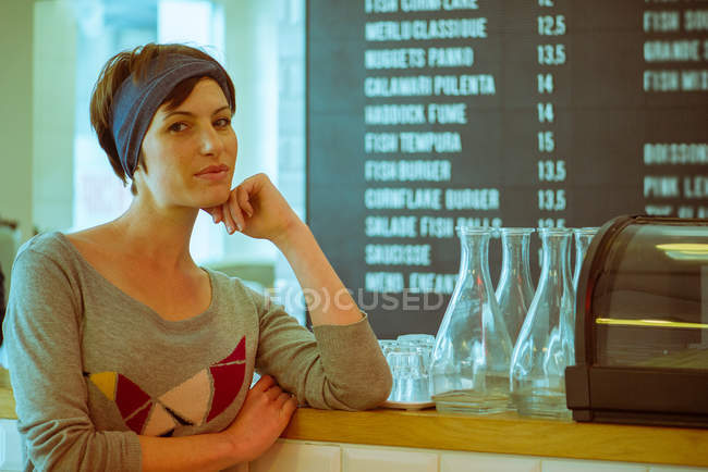 Portrait of Cafe owner standing at the counter — Stock Photo