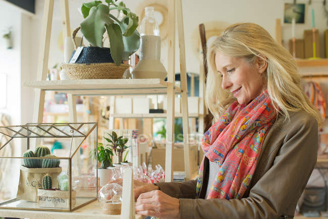 Mature woman shopping in home decorating store — Stock Photo