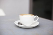 Cup of aroma coffee with foam — Stock Photo