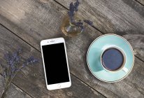 Smartphone and coffee cup — Stock Photo
