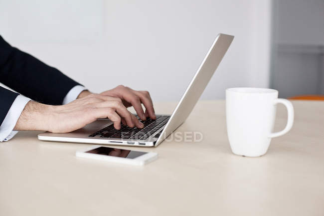 Male hands using laptop — Stock Photo