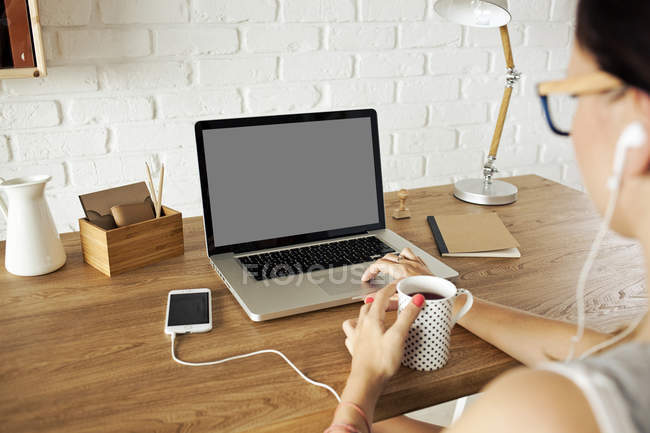Woman at workplace drinking coffe — Stock Photo