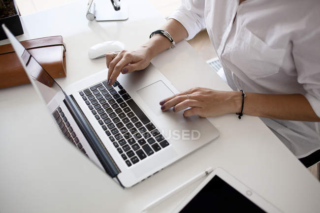 Hands typing on laptop keyboard — Stock Photo