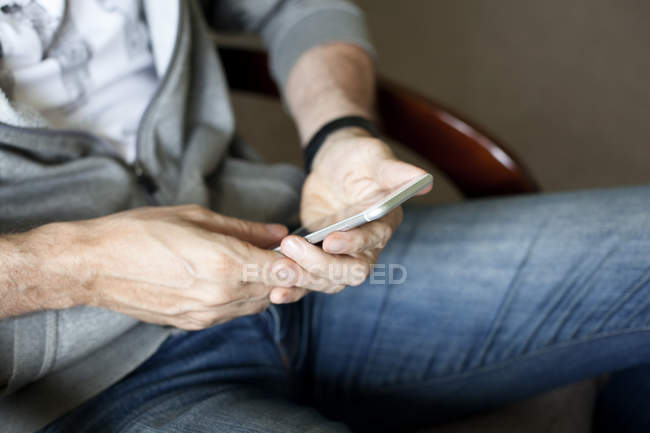 Male hands holding smartphone — Stock Photo