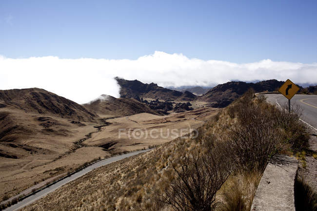 Deserted landscape by the roadwith clouds on mountains in sunny daytime, Argentina — Stock Photo