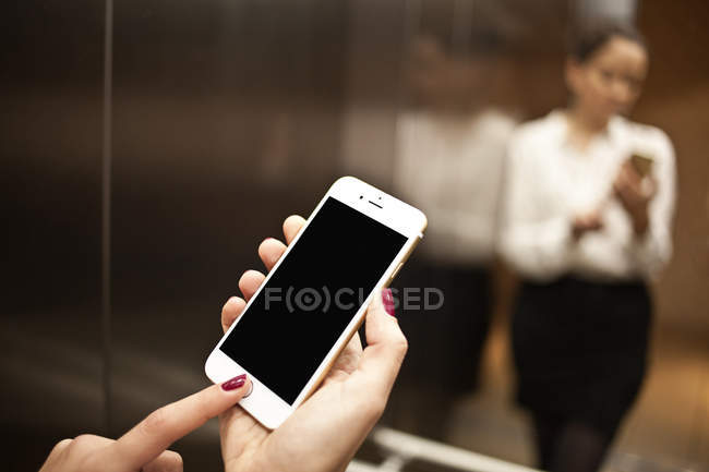 Hands holding smartphone — Stock Photo