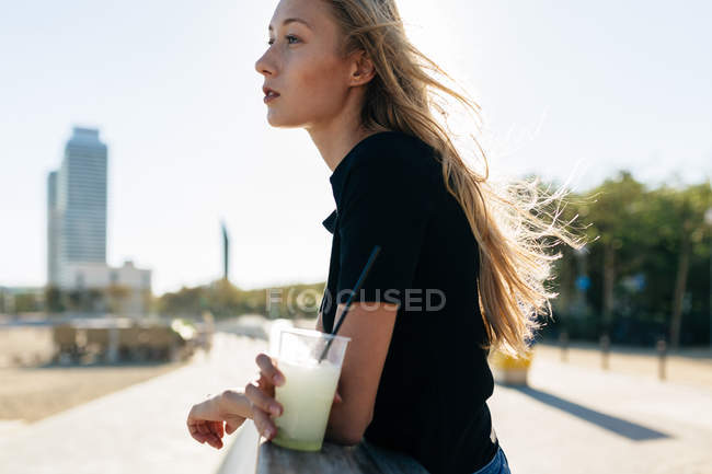Girl leaning on fence — Stock Photo