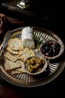 Close-up of Cheese platter with crackers and chutney — Stock Photo