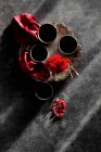 Cups on metal tray with red flowers — Stock Photo