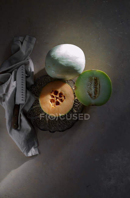 Fresh whole and halved melons — Stock Photo