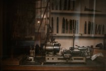 View of grinder machine in workshop window beyond glass pane — Stock Photo