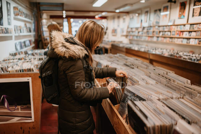 Side view of young women in vinyl shop — Stock Photo