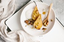 Poached pears with caramelized nuts — Stock Photo