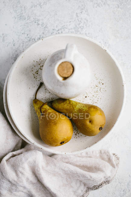 Pears  on white ceramic plate — Stock Photo