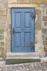 Vintage blue door in brick wall — Stock Photo