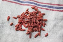 Close up view of goji berries on rural towel — Stock Photo