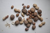 Directly above shot of various nuts on grey surface — Stock Photo
