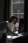 Woman using computer in office — Stock Photo