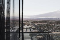 Cityscape seen through balcony against sunny desert sky — Stock Photo