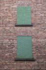 Exterior of brick wall with blocked windows — Stock Photo