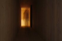 Long exposure of person walking through corridor — Stock Photo