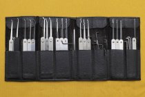 Lock picking set in leather pouch on yellow background — Stock Photo