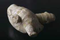 Close up view of ginger root over dark background — Stock Photo