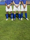 Three soccer players protecting themselves from a free kick — Stock Photo