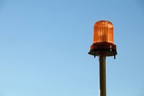 Warning light with blue background of sky — Stock Photo