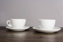 Two white ceramic cups  on table — Stock Photo