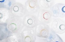 Directly above view of empty plastic bottles over white — Stock Photo
