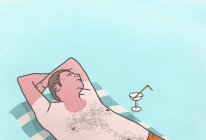 Sunburned man with cocktail sleeping on towel — Stock Photo