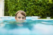 Portrait of boy swimming in swimming pool — Stock Photo