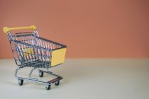 Tiny toy shopping cart — Stock Photo