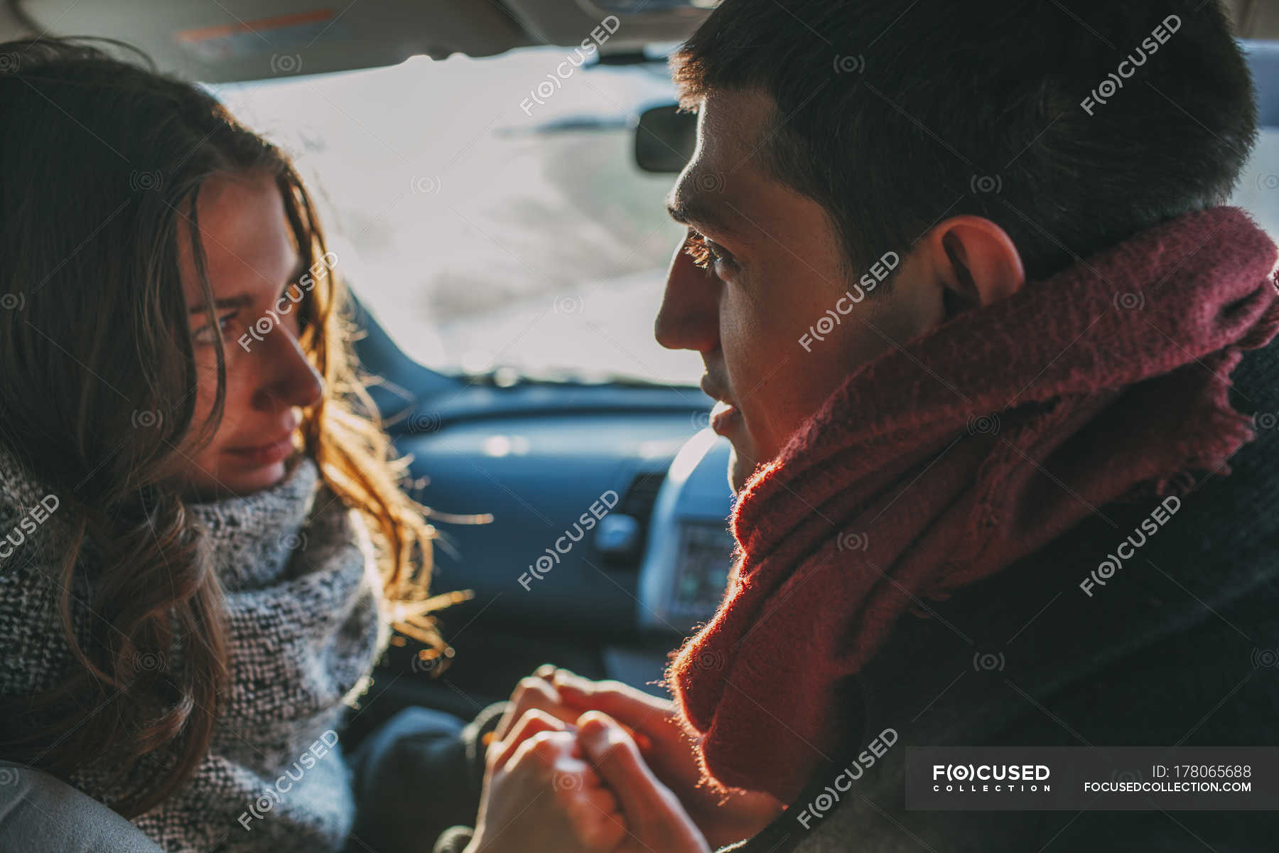 couple holding hands in the car