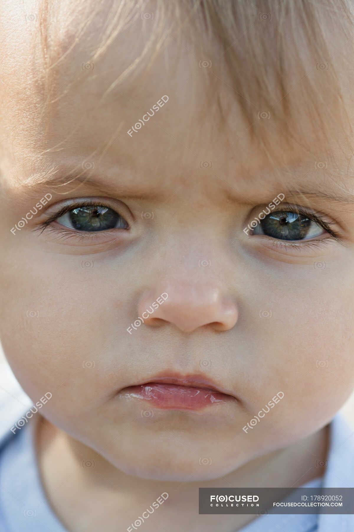 A young girl frowning in concentration, close-up of face — Baby Girls