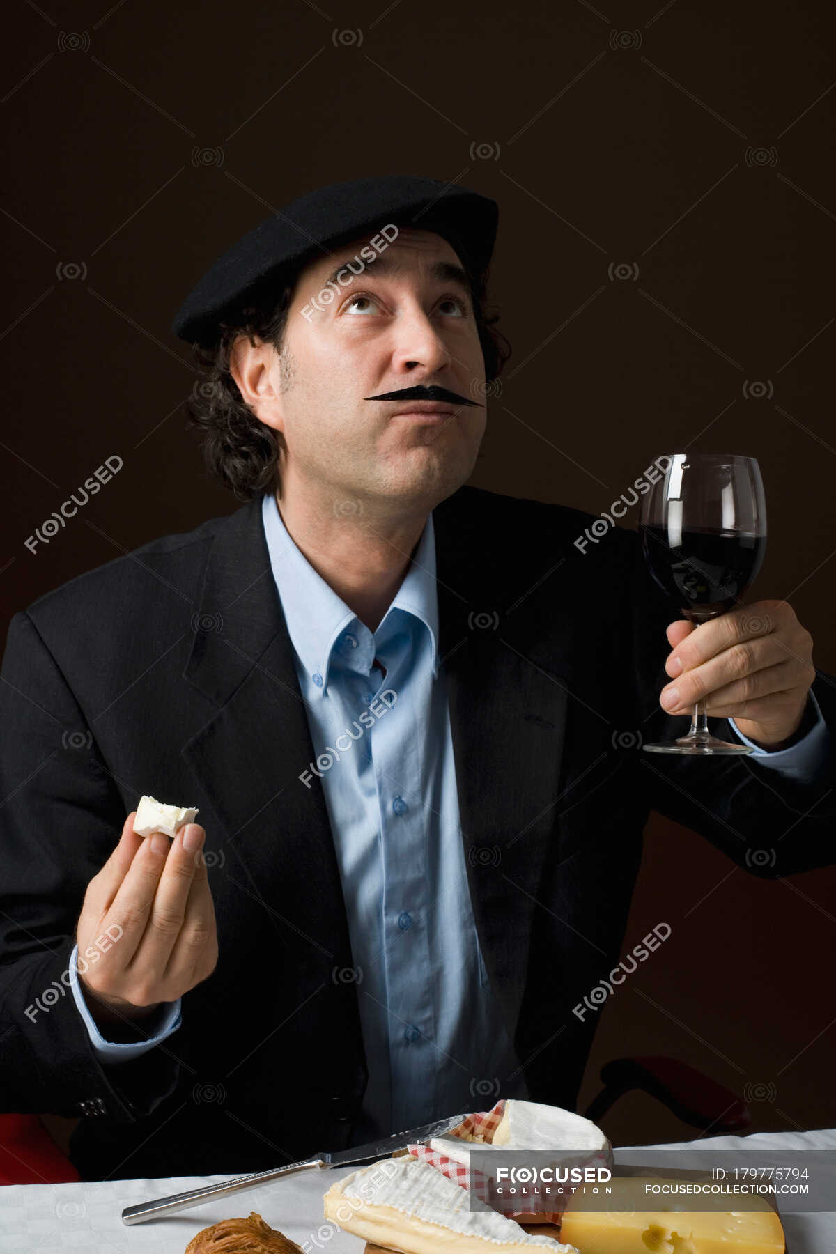 stereotypical-french-man-with-french-cheese-and-a-glass-of-red-wine