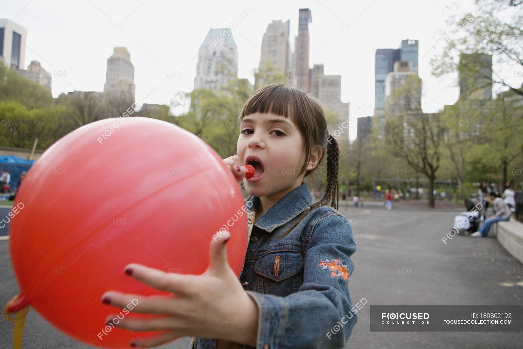 Girl Blowing Balloons