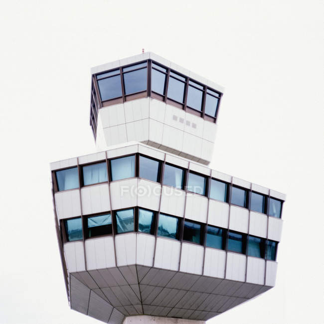 Vista ad angolo basso della torre di controllo dell'aeroporto sopra il cielo bianco — Foto stock