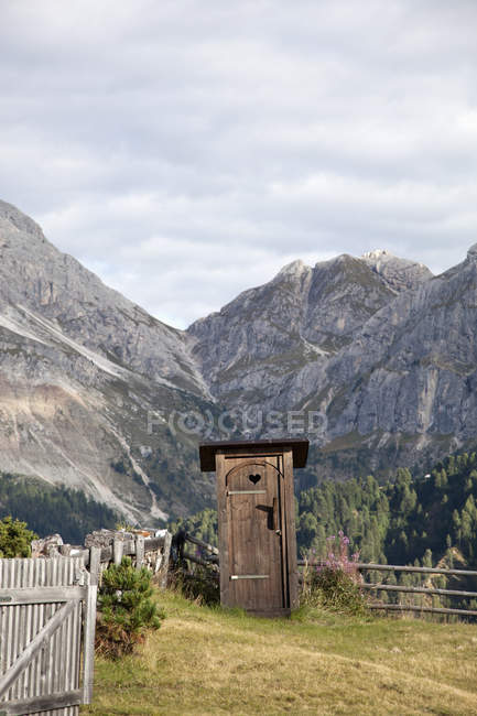 Outhouse over mountains ridges on background — Stock Photo