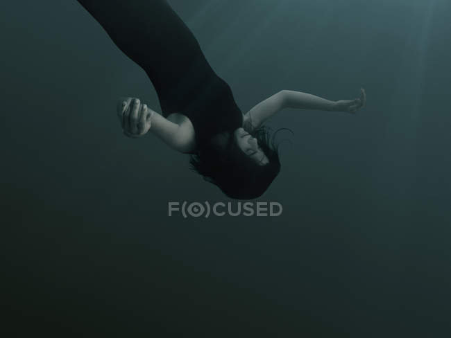 Una donna con gli occhi chiusi ed espressione vuota, che affonda sott'acqua — Foto stock