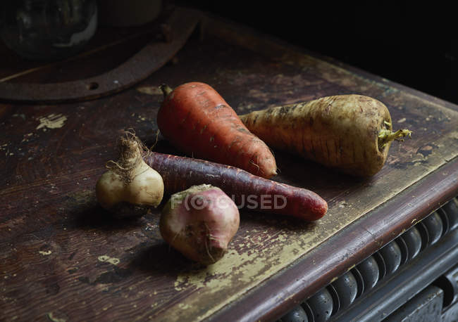 Still life of root vegetables on wooden table — Stock Photo