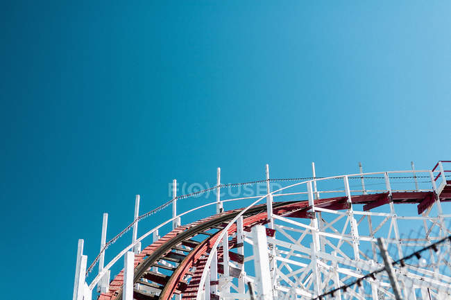 Roller Coaster Track Against Clear Blue Sky Metal Amusement Park Stock Photo
