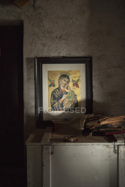 Religious picture frame in abandoned home — Stock Photo