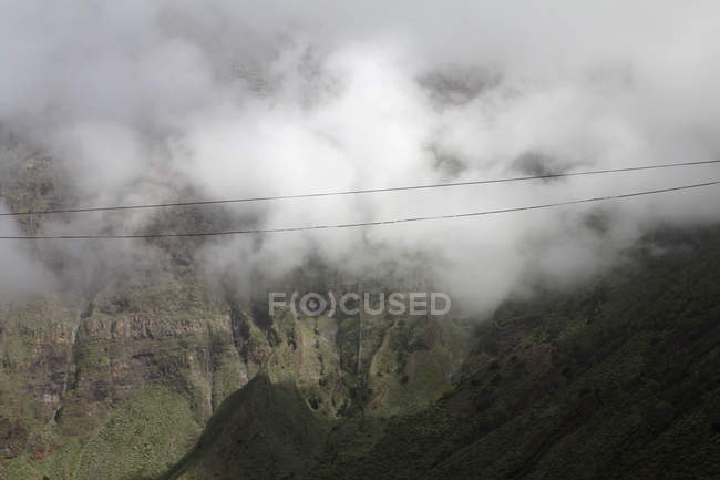 Aerial view of clouds over valley between mountains — Stock Photo