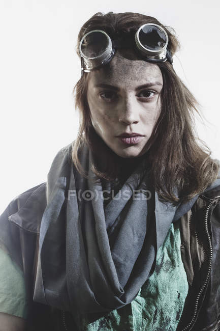 Portrait of young woman wearing goggles and jacket against white background — Stock Photo
